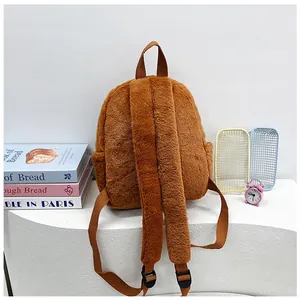 Detail view of the brown plush backpack with soft texture and side storage pockets