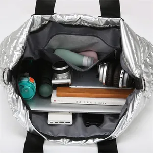 Silver quilted fitness bag showing large capacity for camera, tablet and daily essentials
