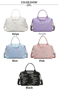 Detail of five multi-color quilted travel bags showing the fold-over flap and leather handles