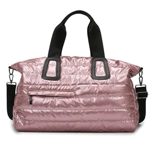 Quilted pink waterproof fitness gym bag with black straps and detachable shoulder strap