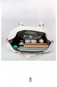 Quilted travel bag interior showing large capacity for camera, tablet, and clothing
