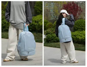 Detail view of light blue travel bag with waterproof material and separate shoe compartment