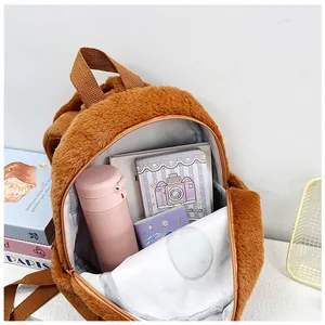 Internal view of brown capybara plush backpack showing spacious capacity for books