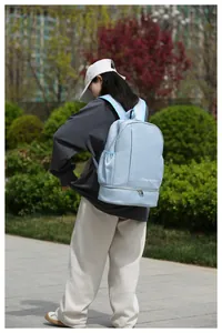 Detail view of light blue travel backpack with wet dry separation and shoe compartment
