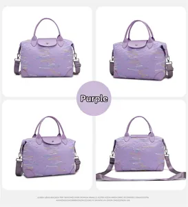 Detail view of purple travel bag featuring colorful embroidery and leather handle details