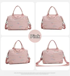 Pink quilted travel bag detail showing the adjustable strap and wave pattern embroidery