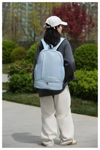 Outdoor shot of light blue travel backpack with waterproof fabric and separate compartments