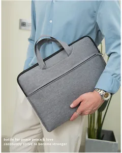 Business grey laptop bag made of waterproof oxford fabric shown held by a model