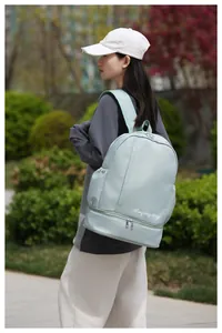 Detailed side view of light green waterproof travel backpack with separate shoe compartment