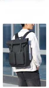 Detail of waterproof roll-top black backpack with dual square front pockets