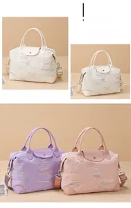 Detail view of large travel bags with embossed texture and detachable canvas straps