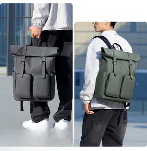 Waterproof roll-top backpack detail showing dark grey and green colors and dual carry modes