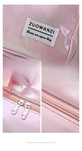 Detail view of pink holographic swim bag featuring dual metal zippers and brand logo tag