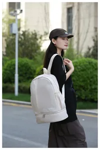 Outdoor shot of a cream water-resistant nylon travel backpack with a large capacity