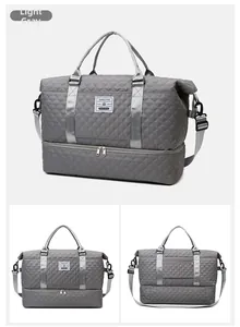 Detail view of light grey quilted travel bag featuring a separate bottom shoe compartment