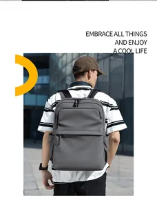 Modern grey waterproof PU backpack for 15.6 inch laptop shown on male model in city setting