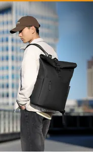 Waterproof black roll-top backpack shown on model against a modern city skyline background