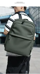 Deep green water-resistant PU backpack for 15.6 inch laptops shown on a male model