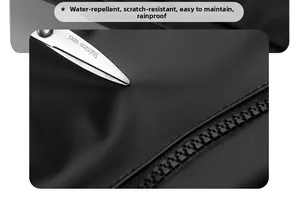 Macro detail of waterproof black functional fabric and smooth resin zipper on backpack