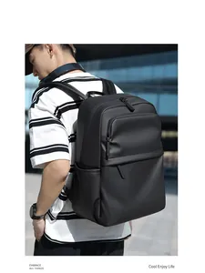 Detail of a sleek black waterproof laptop backpack shown from a side-rear outdoor view