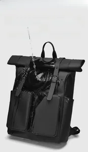 Close-up showing the water-repellent performance on the black matte backpack fabric