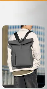 Detail view of a waterproof dark grey roll-top backpack with vertical front zipper pocket