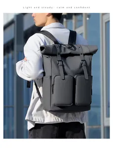 Detail of grey roll-top backpack with waterproof fabric and dual front buckled pockets