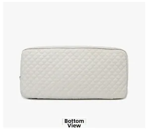 Detailed bottom view of quilted travel bag showing premium diamond stitching and structure