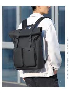 Detail of waterproof matte black roll-top backpack with dual front cargo pockets on the back
