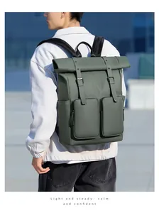 Detail of army green roll-top backpack with waterproof fabric and dual zipper pockets