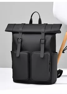 Close-up of roll-top black waterproof backpack with dual zipper pockets and matte finish