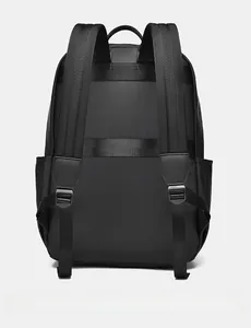 Back view of black waterproof laptop backpack showing luggage strap and padded straps