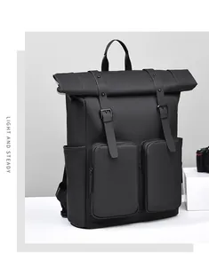 Detail view of matte black functional backpack with flap closure and dual front pockets