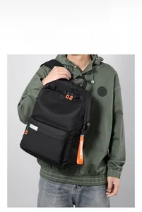Detail of multi-functional backpack with orange zippers and durable nylon material