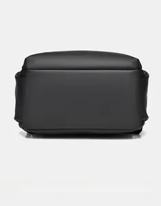 Detailed bottom view of black PU leather laptop backpack showing wide base and neat stitching