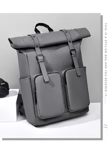 Detail of roll-top backpack with dual front zip pockets and waterproof matte material