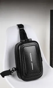 Close-up of carbon fiber texture and combination lock on black hardshell sling bag