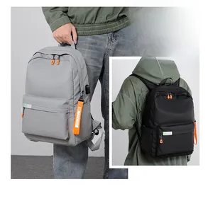 Detail view of large capacity backpack featuring USB charging port and safety reflective strip