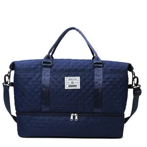 Navy blue quilted travel bag with large capacity, shoe compartment and adjustable shoulder strap