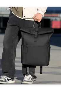 Waterproof roll-top backpack held by model, showing size and urban style outdoors
