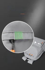 Detail of dark grey backpack featuring safety reflective stripes and orange zipper pulls