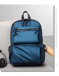 Close-up of blue nylon backpack with multi-layer zipper pockets on a gray sofa