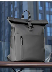 Detailed view of the roll-top closure and waterproof matte black fabric on the backpack