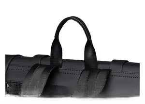 Detail of the reinforced padded top handle on a black nylon and leather backpack