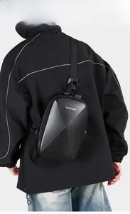 Close-up of black carbon fiber hard shell chest bag with USB port and adjustable strap