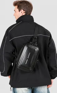 Detailed back view of a black carbon fiber texture chest bag on a male model outdoors