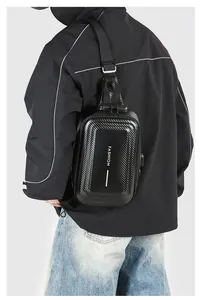 Detail of black hard shell chest bag with carbon fiber texture and anti-theft lock