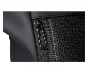 Close-up of premium metal zipper and breathable mesh fabric on a black travel backpack