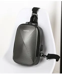 Detail of hardshell chest bag showing carbon fiber texture, combination lock, and USB port