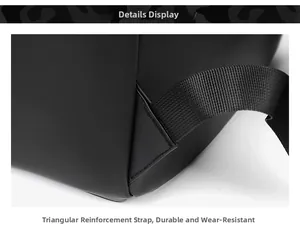 Detail view of triangular reinforcement on black backpack strap for extra durability